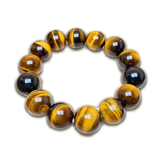 Polished tiger's eye bead bracelet with golden brown and black striped gemstones on white background