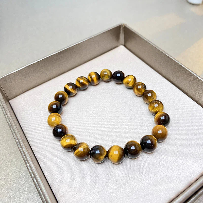 Tiger eye gemstone beaded bracelet inside a beige jewelry box on a light surface