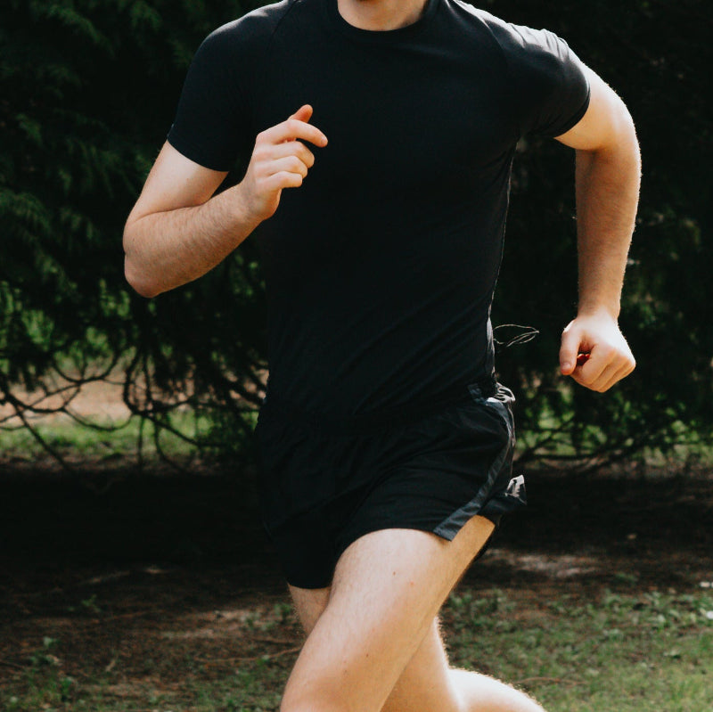 Person running outdoors with trees in the background